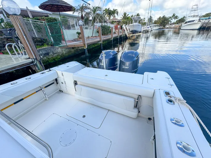  Yacht Photos Pics 2013 Edgewater 318CC boat docked, featuring spacious deck and twin outboard engines.