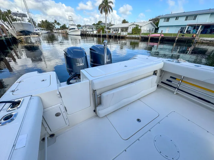  Yacht Photos Pics 2013 Edgewater 318CC boat with twin engines docked in a serene marina setting.