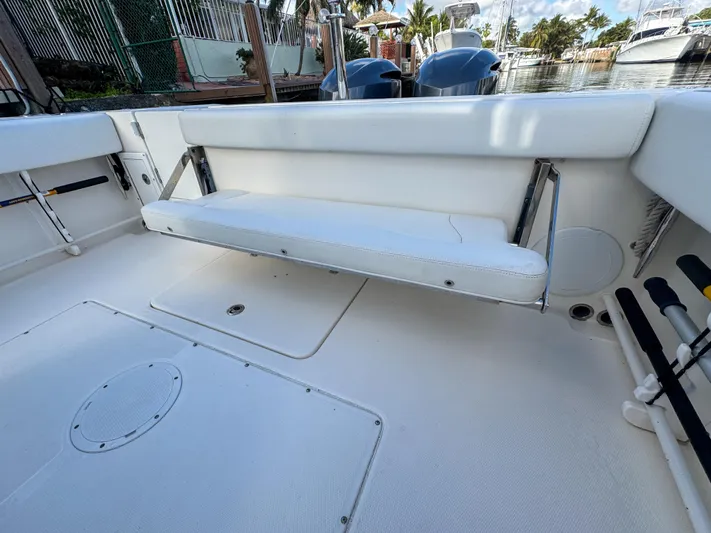  Yacht Photos Pics 2013 Edgewater 318CC boat interior with foldable bench seat and storage compartments.