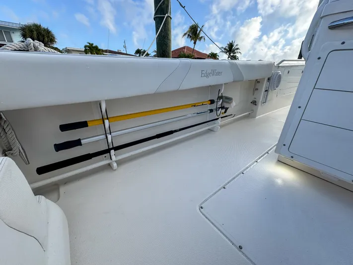  Yacht Photos Pics 2013 Edgewater 318CC boat interior with fishing rod storage and clear sky background.