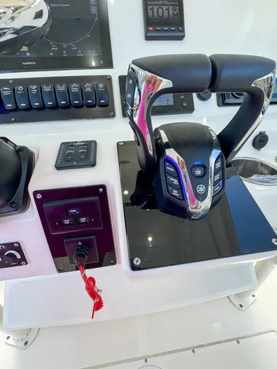  Yacht Photos Pics Control panel of 2013 Edgewater 318CC boat with steering and navigation equipment.