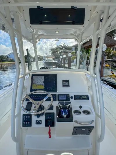  Yacht Photos Pics 2013 Edgewater 318CC boat dashboard with steering wheel and navigation controls.