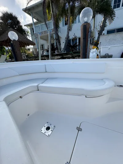  Yacht Photos Pics 2013 Edgewater 318CC boat interior with white seating, docked near a waterfront home.