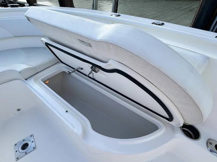  Yacht Photos Pics Open storage compartment on a 2013 Edgewater 318CC boat, showcasing spacious interior.