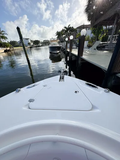  Yacht Photos Pics Bow view of 2013 Edgewater 318CC boat docked in a scenic waterfront setting.