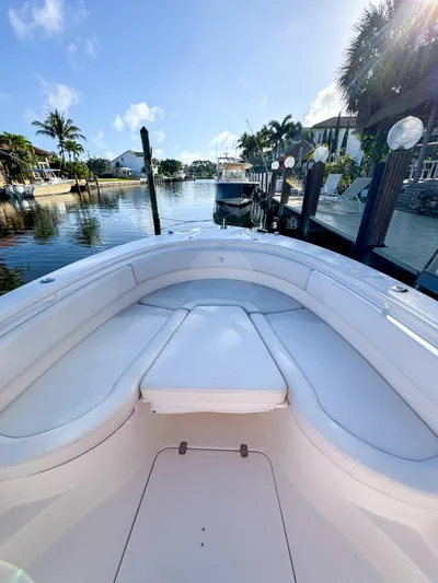  Yacht Photos Pics 2013 Edgewater 318CC boat docked in a scenic waterfront setting.