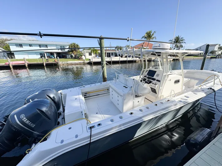  Yacht Photos Pics 2013 Edgewater 318CC boat docked, featuring dual Yamaha engines, in a sunny marina setting.