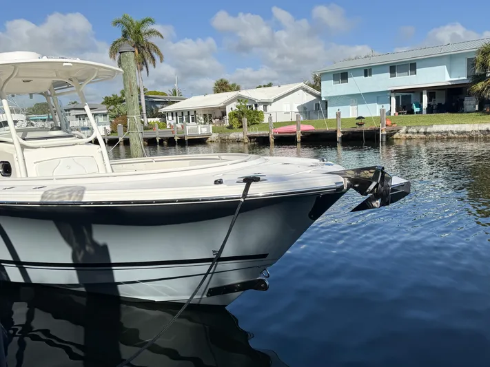  Yacht Photos Pics Edgewater 318CC boat docked by waterfront homes, clear sky, calm water, 2013 model.