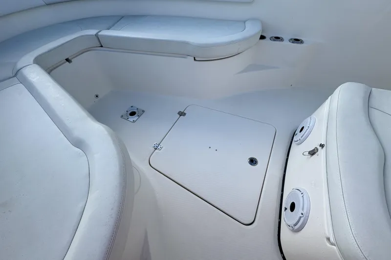  Yacht Photos Pics 2013 Edgewater 318CC boat interior with white seating and storage compartments.