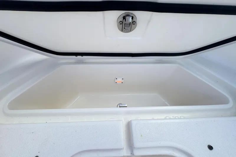  Yacht Photos Pics Open storage compartment of 2013 Edgewater 318CC boat, featuring a secure latch.