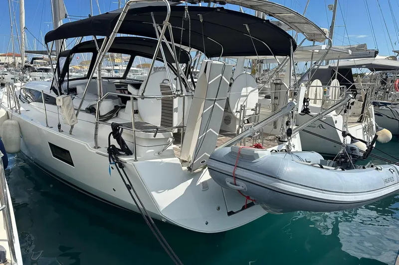  Yacht Photos Pics 2019 Jeanneau 51 yacht docked with inflatable dinghy, featuring sleek design and spacious deck.