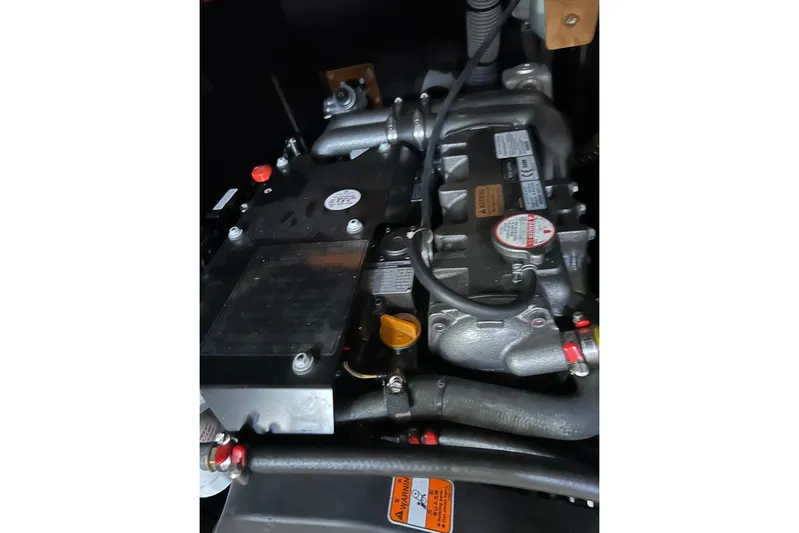  Yacht Photos Pics Engine compartment of a 2019 Jeanneau 51 yacht, showcasing mechanical components and labels.