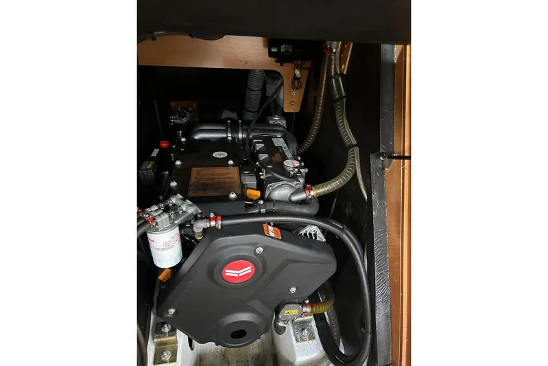 Yacht Photos Pics Engine compartment of a 2019 Jeanneau 51 sailboat, showcasing mechanical components and hoses.