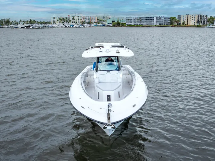 Seakeeper Equipped Yacht Photos Pics 2024 HCB 42 Lujo boat on calm water with cityscape background.