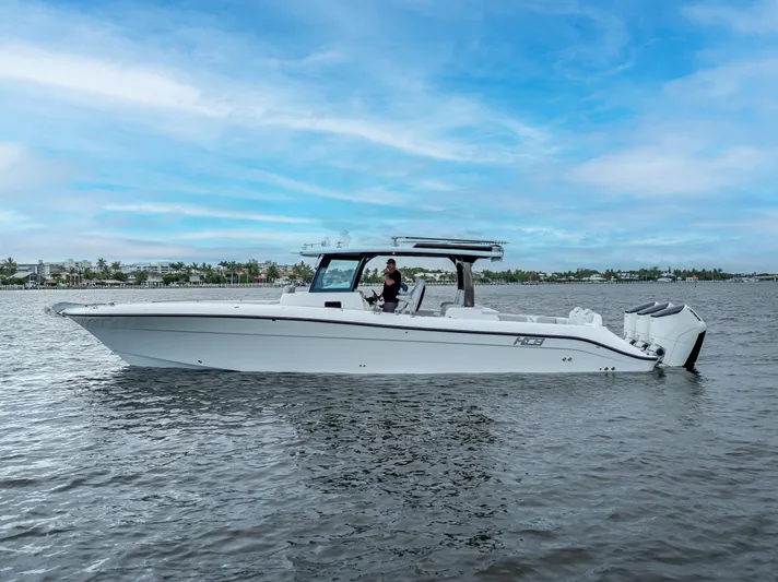 Seakeeper Equipped Yacht Photos Pics 2024 HCB 42 Lujo boat on calm water under a clear blue sky.