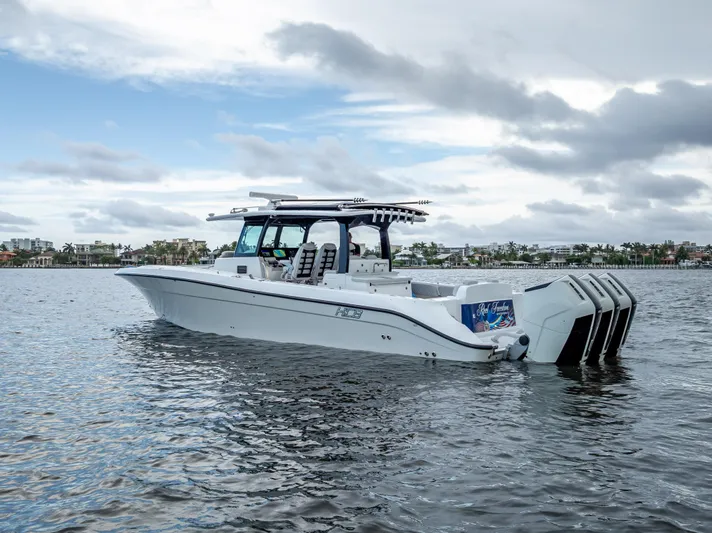 Seakeeper Equipped Yacht Photos Pics 2024 HCB 42 Lujo boat on water, featuring multiple outboard engines.
