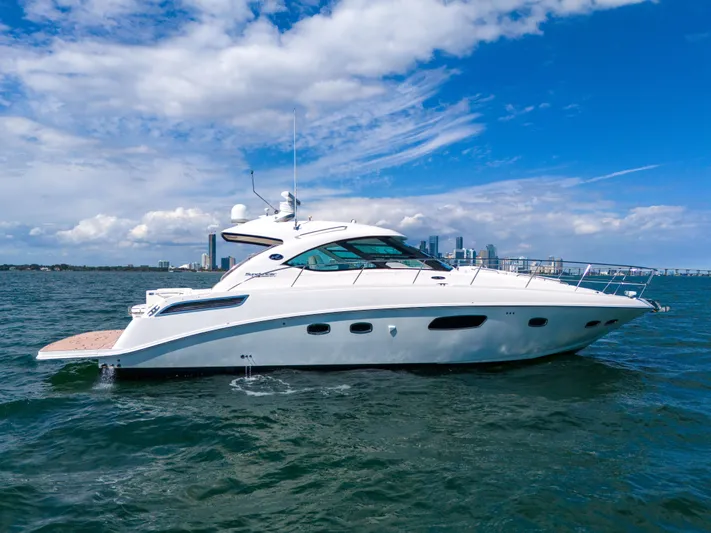  Yacht Photos Pics 2011 Sea Ray 470 Sundancer yacht cruising on open water under a clear blue sky.