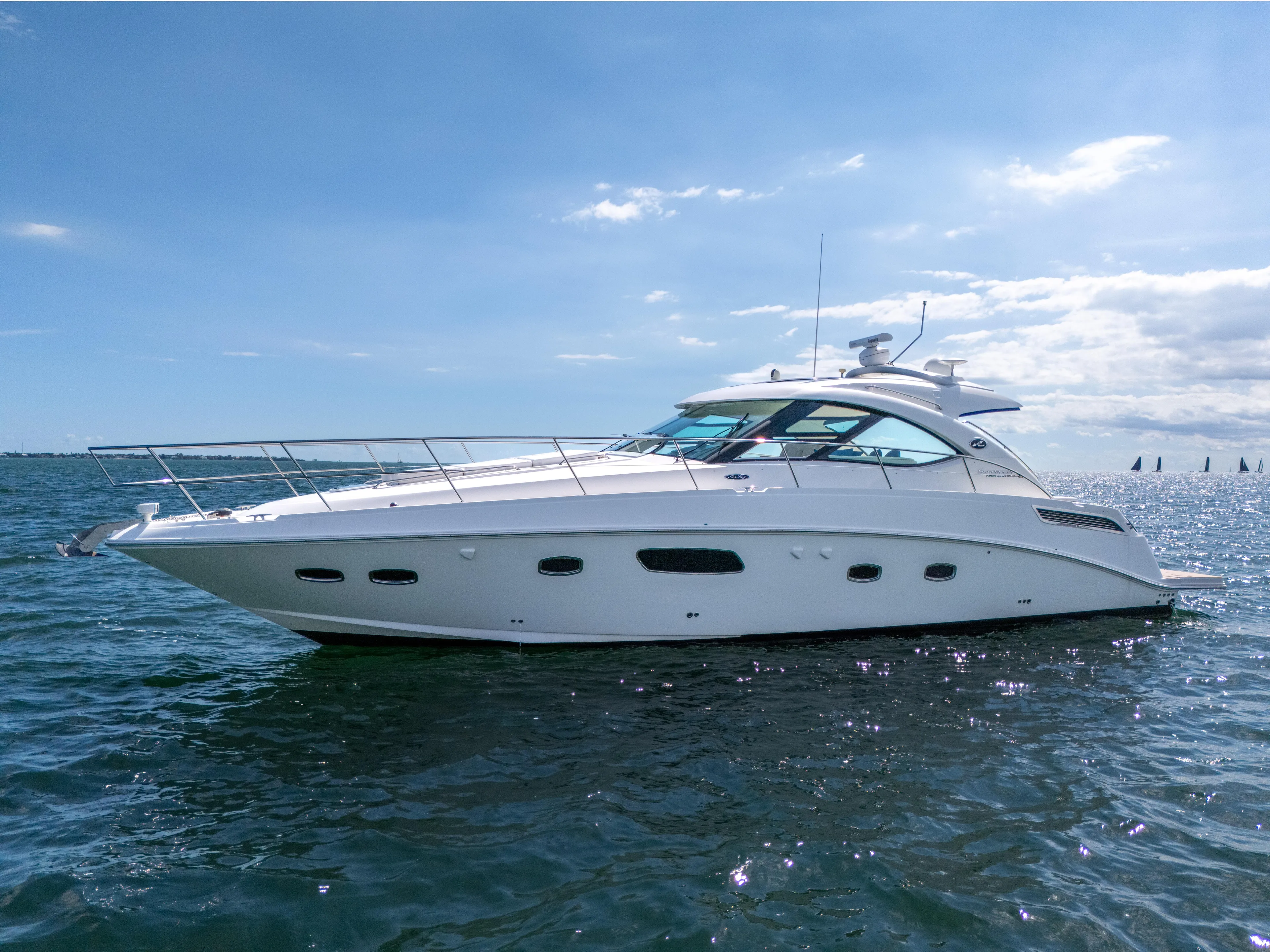  Yacht Photos Pics 2011 Sea Ray 470 Sundancer yacht on open water under clear blue sky.