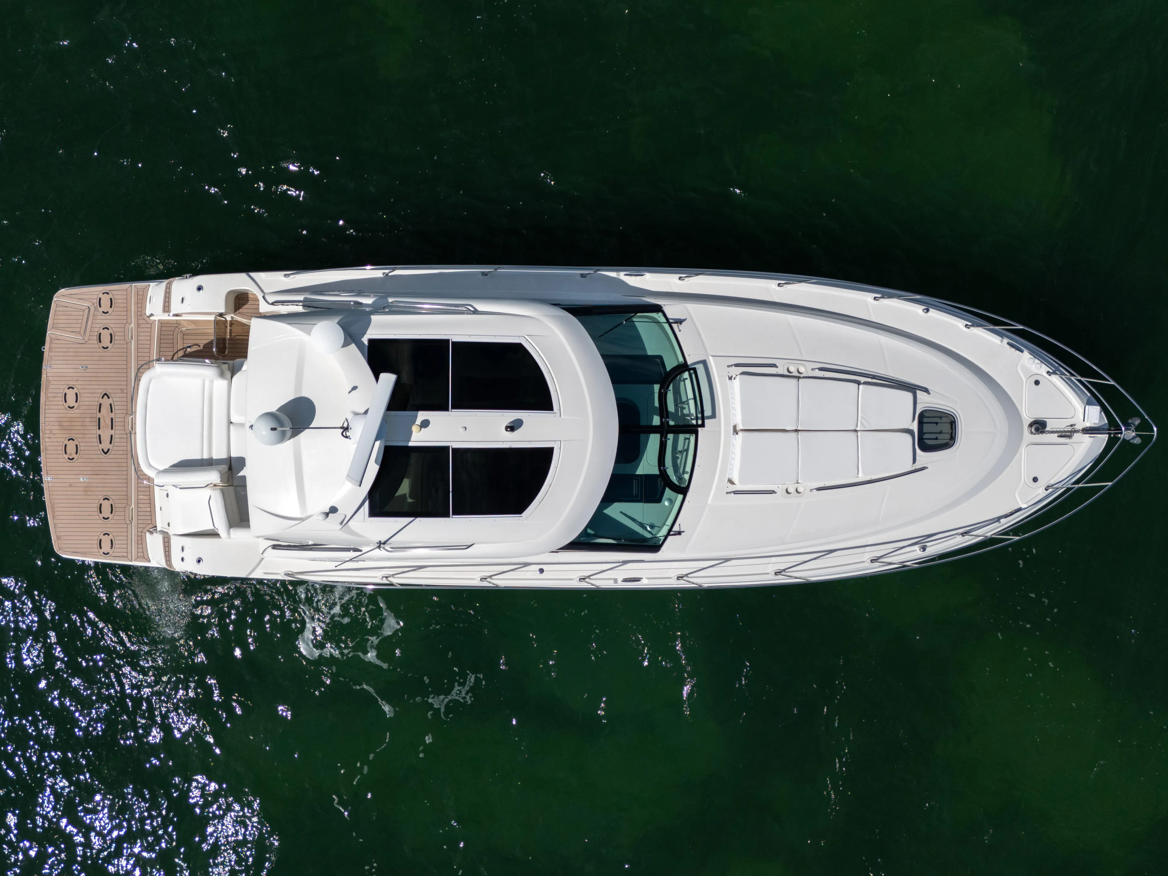  Yacht Photos Pics Overhead view of 2011 Sea Ray 470 Sundancer yacht on green water.
