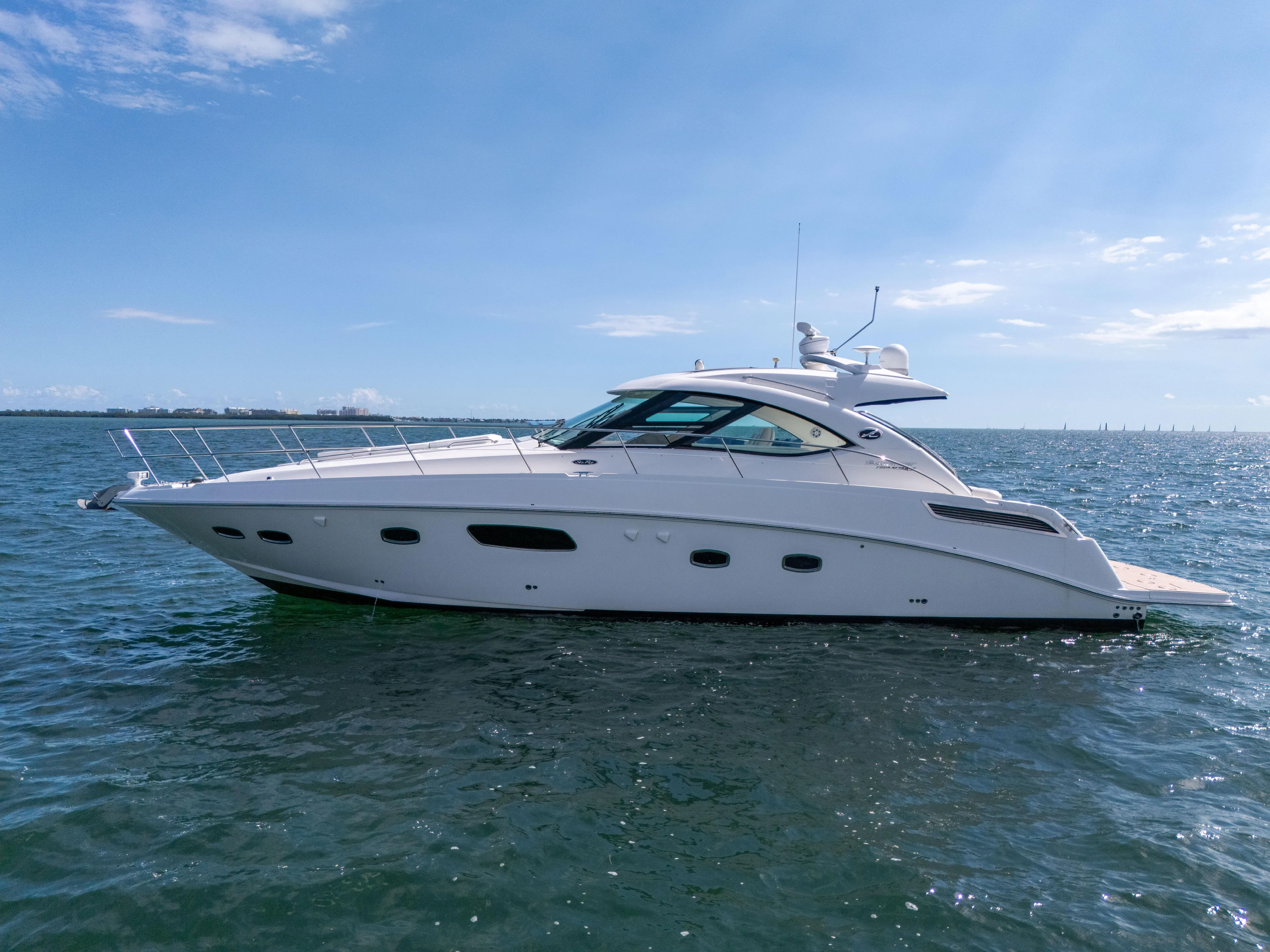  Yacht Photos Pics 2011 Sea Ray 470 Sundancer yacht cruising on open water under clear blue skies.