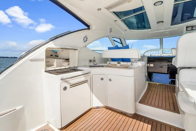  Yacht Photos Pics Luxurious interior of 2011 Sea Ray 470 Sundancer yacht with modern amenities and wooden flooring.