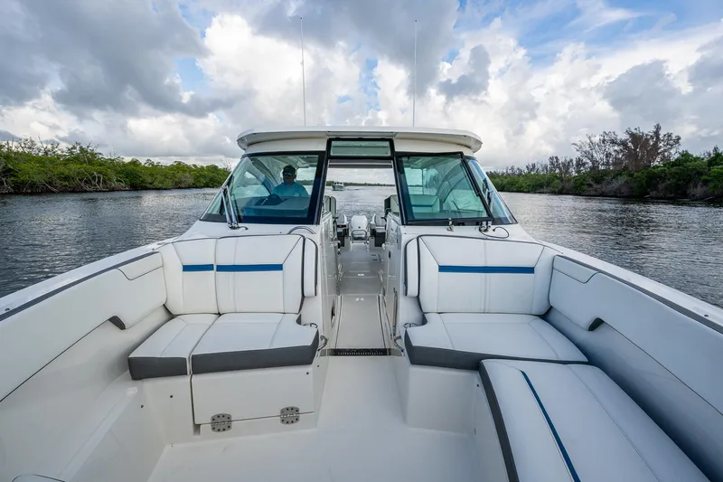  Yacht Photos Pics 2021 Tiara Yachts 38 LX with spacious seating, cruising on a scenic waterway.