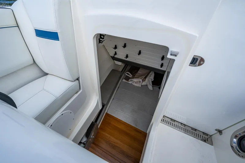  Yacht Photos Pics Interior storage compartment of 2021 Tiara Yachts 38 LX, featuring white seating and wooden flooring.