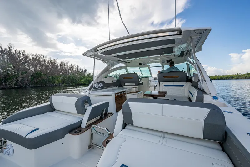  Yacht Photos Pics 2021 Tiara Yachts 38 LX luxury boat interior with seating, on a calm waterway.