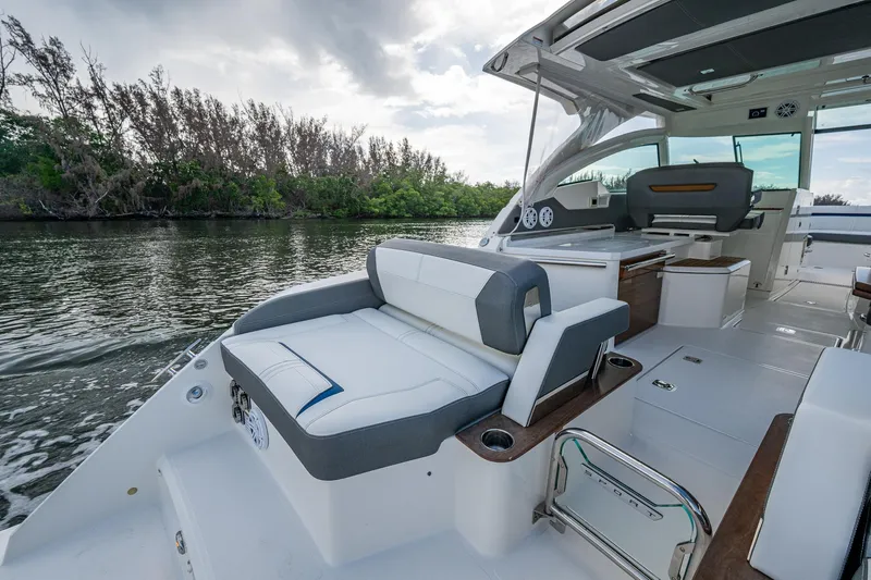  Yacht Photos Pics 2021 Tiara Yachts 38 LX luxury boat interior with seating, on a calm river.