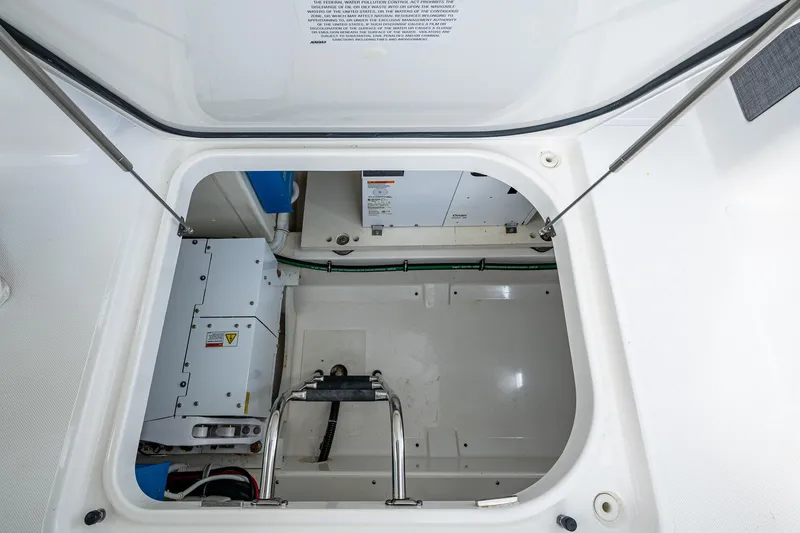  Yacht Photos Pics Engine compartment of 2021 Tiara Yachts 38 LX, showcasing mechanical components and storage space.
