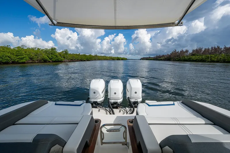  Yacht Photos Pics 2021 Tiara Yachts 38 LX with triple engines cruising on a scenic waterway.