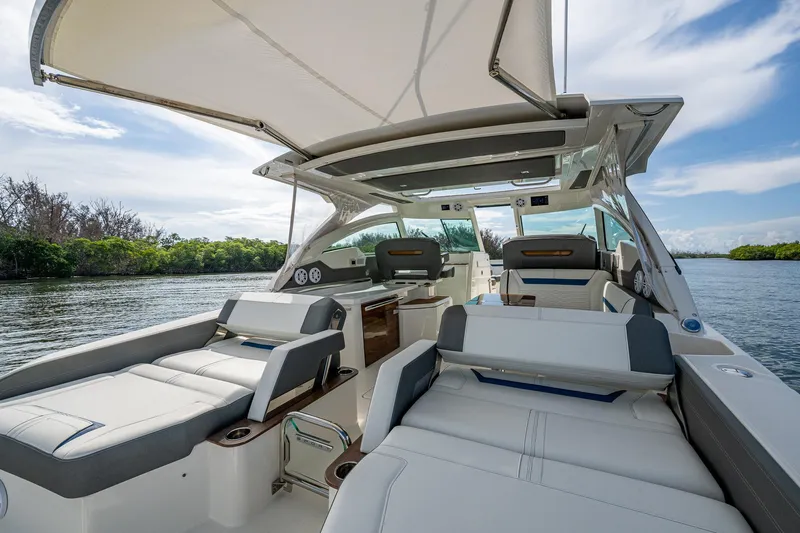  Yacht Photos Pics 2021 Tiara Yachts 38 LX luxury boat interior with seating, canopy, and scenic water view.