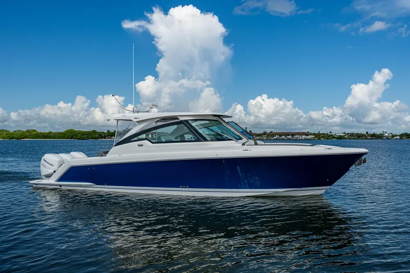  Yacht Photos Pics 2021 Tiara Yachts 38 LX cruising on a sunny day with blue skies.