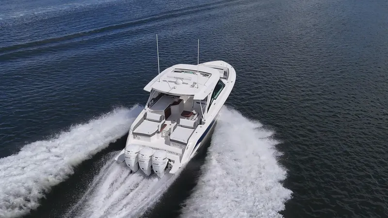  Yacht Photos Pics 2021 Tiara Yachts 38 LX cruising on open water, showcasing powerful triple engines.