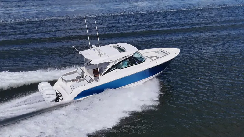  Yacht Photos Pics 2021 Tiara Yachts 38 LX cruising on open water, showcasing sleek design and powerful performance.