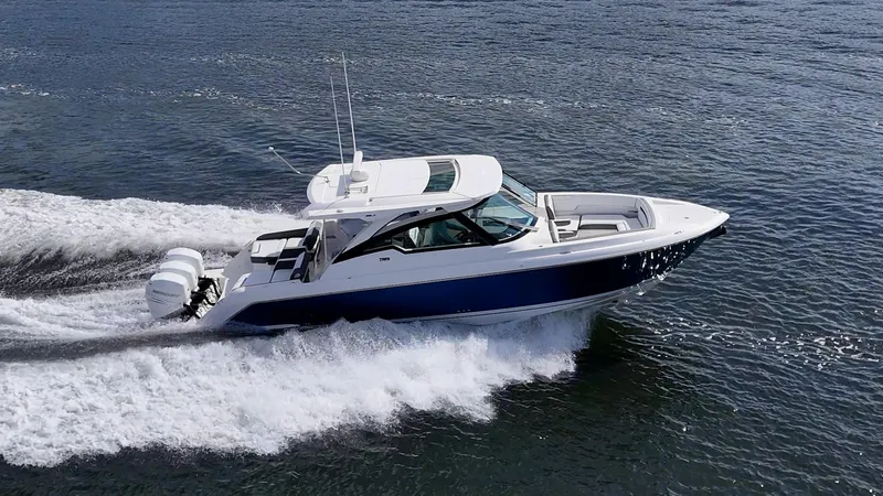  Yacht Photos Pics 2021 Tiara Yachts 38 LX cruising on open water, showcasing sleek design and powerful engines.