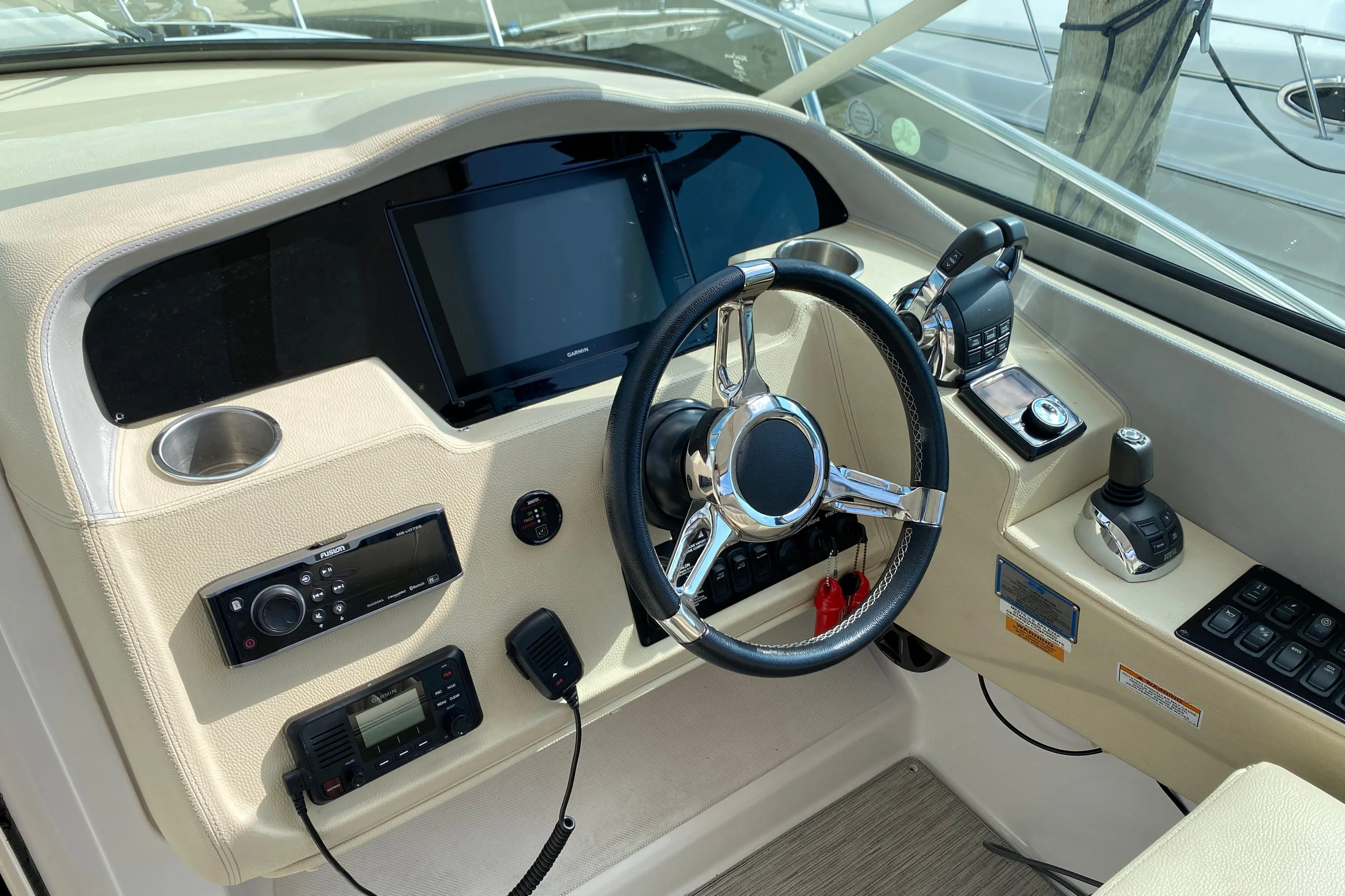 2019 Regal 33 Express boat helm with steering wheel and control panel.