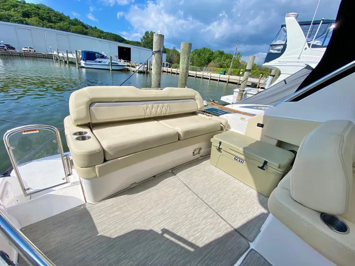  Yacht Photos Pics 2019 Regal 33 Express boat with beige seating at a marina.
