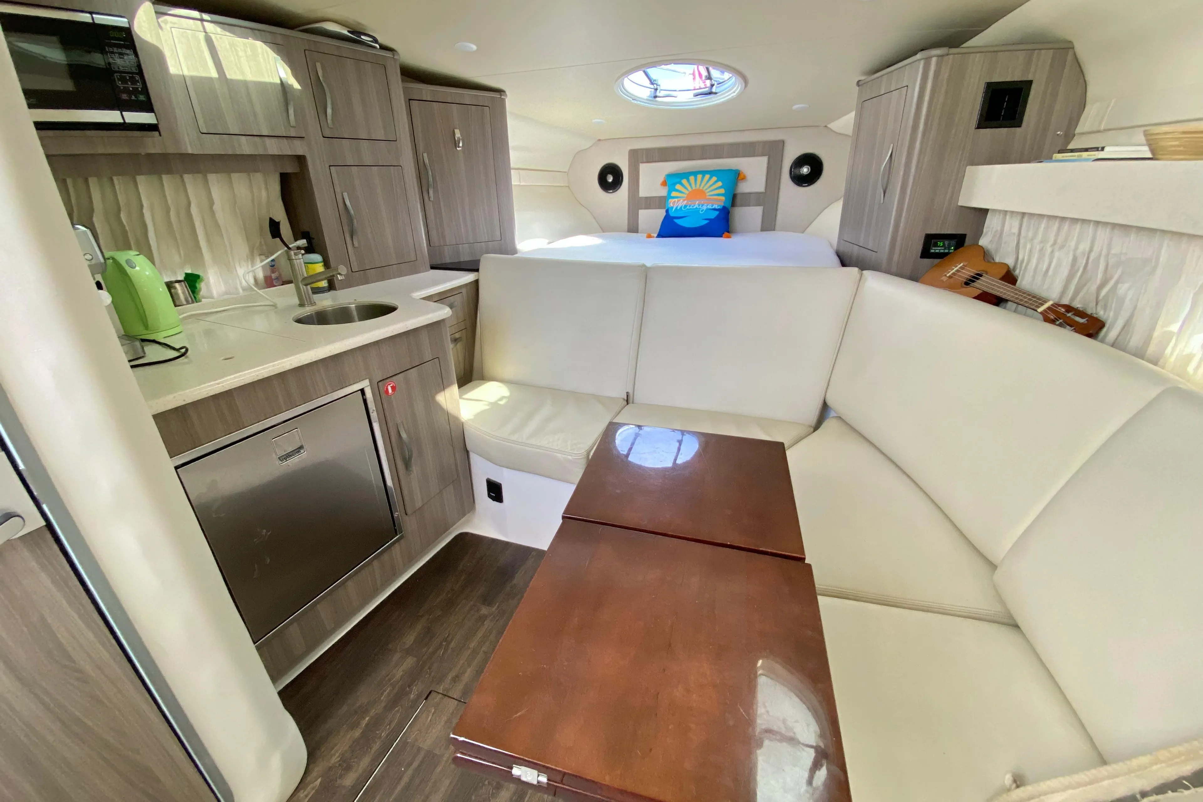 Interior of 2019 Regal 33 Express yacht with kitchenette and seating area.