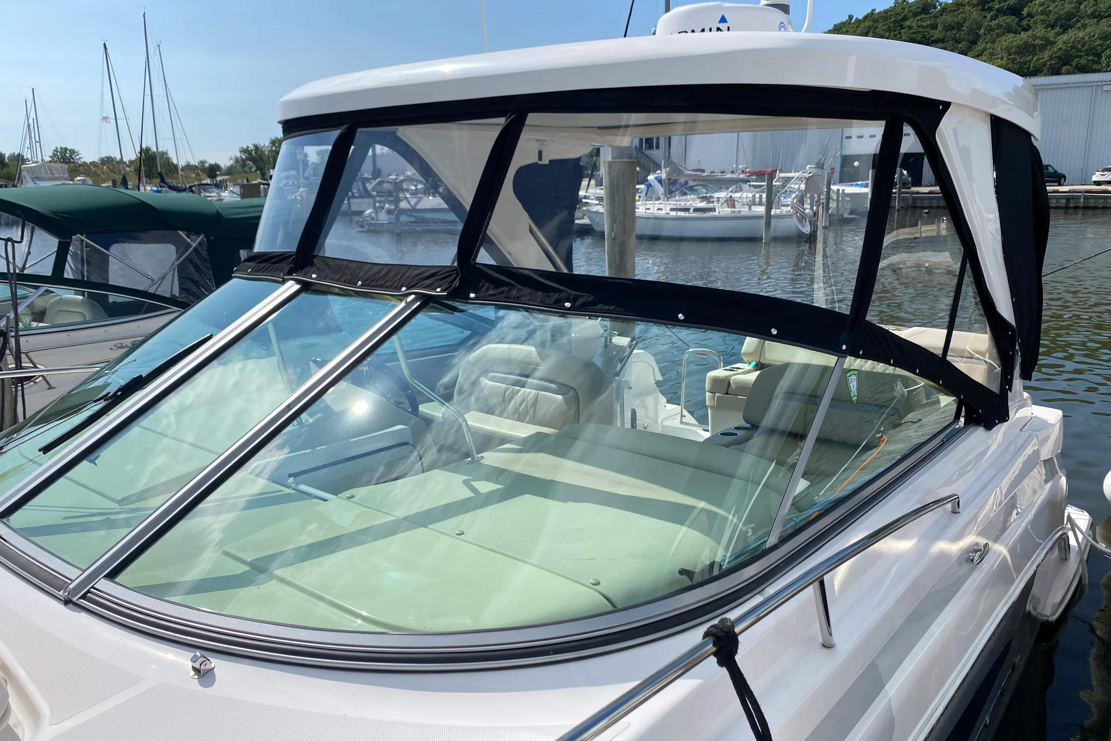 2019 Regal 33 Express boat docked at marina with clear canopy.