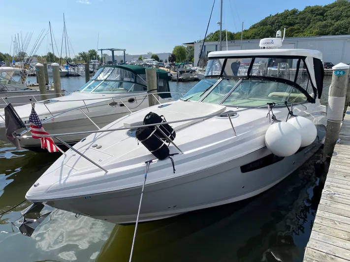  Yacht Photos Pics 2019 Regal 33 Express boat docked at a marina with other boats.