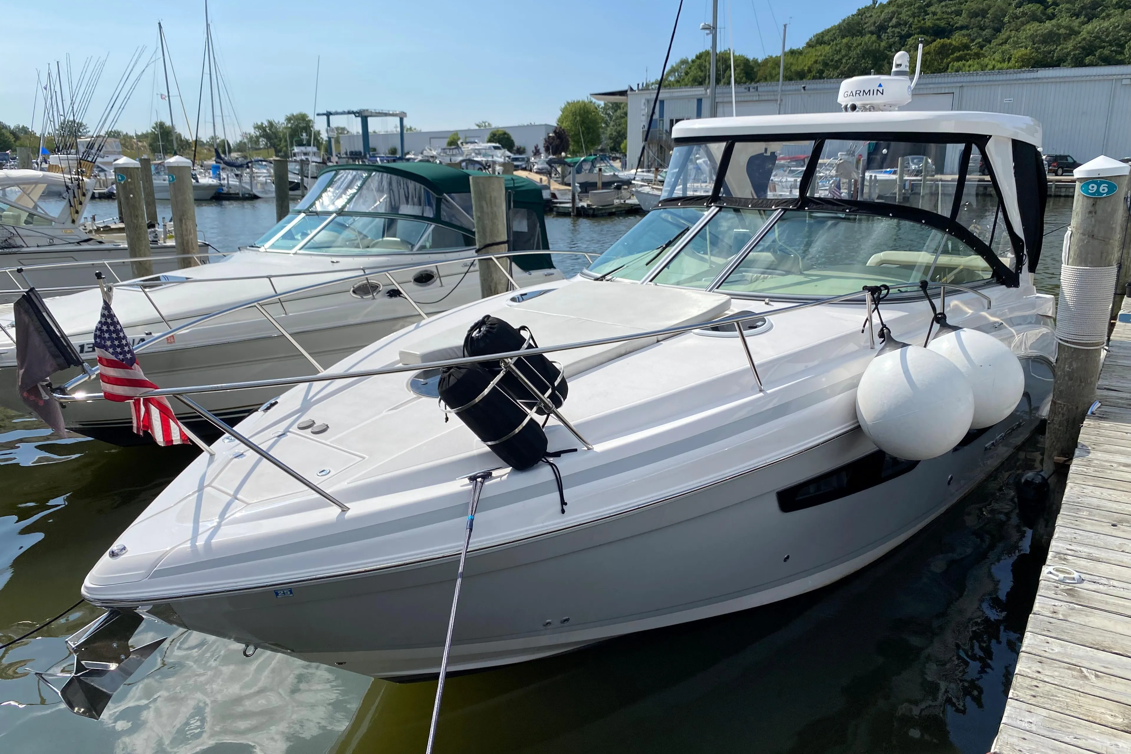 2019 Regal 33 Express boat docked at a marina with other boats.