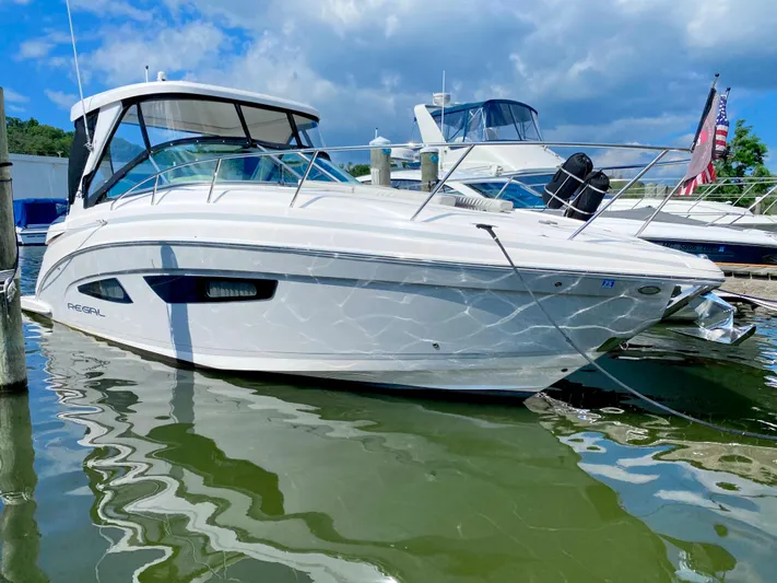  Yacht Photos Pics 2019 Regal 33 Express boat docked at a marina on a sunny day.