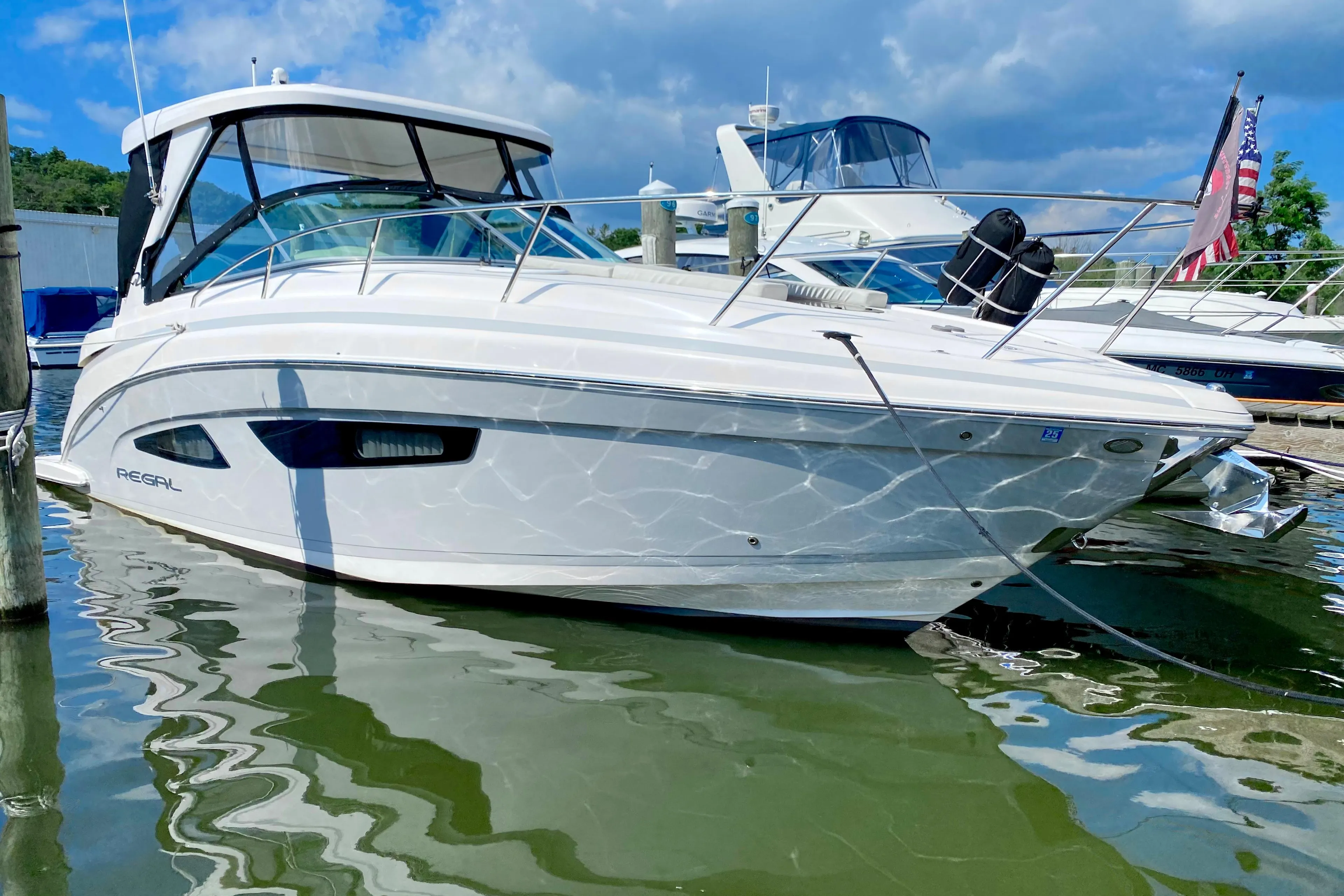 2019 Regal 33 Express boat docked at a marina on a sunny day.