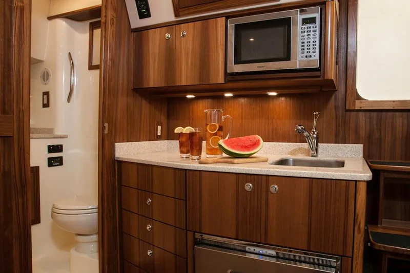 Yacht Photos Pics Manufacturer Provided Image: 2018 Albemarle 36 Express yacht interior kitchen with microwave, sink, and refreshments.