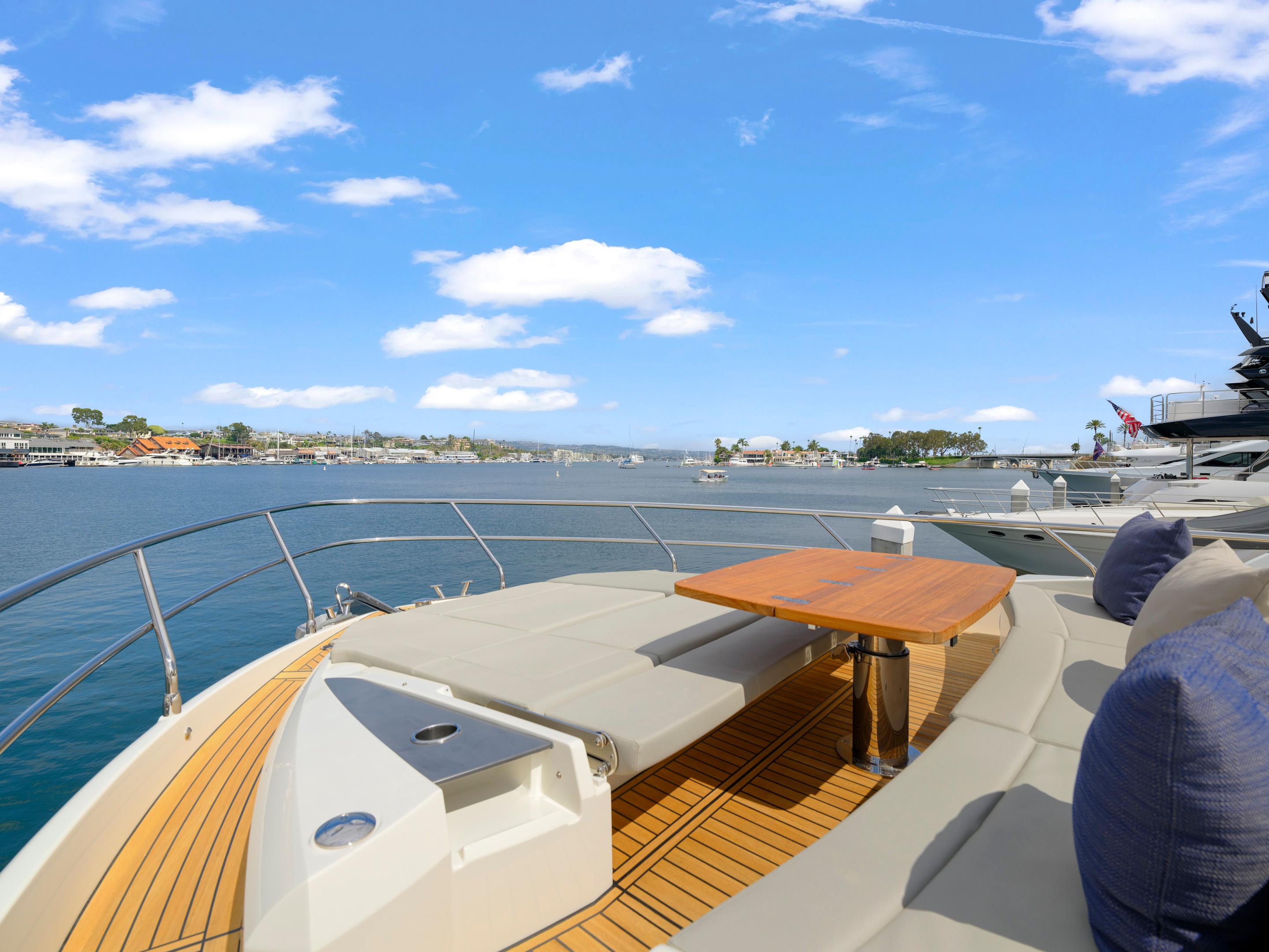 Luxurious 2024 Absolute 60 Fly yacht deck with scenic waterfront view.