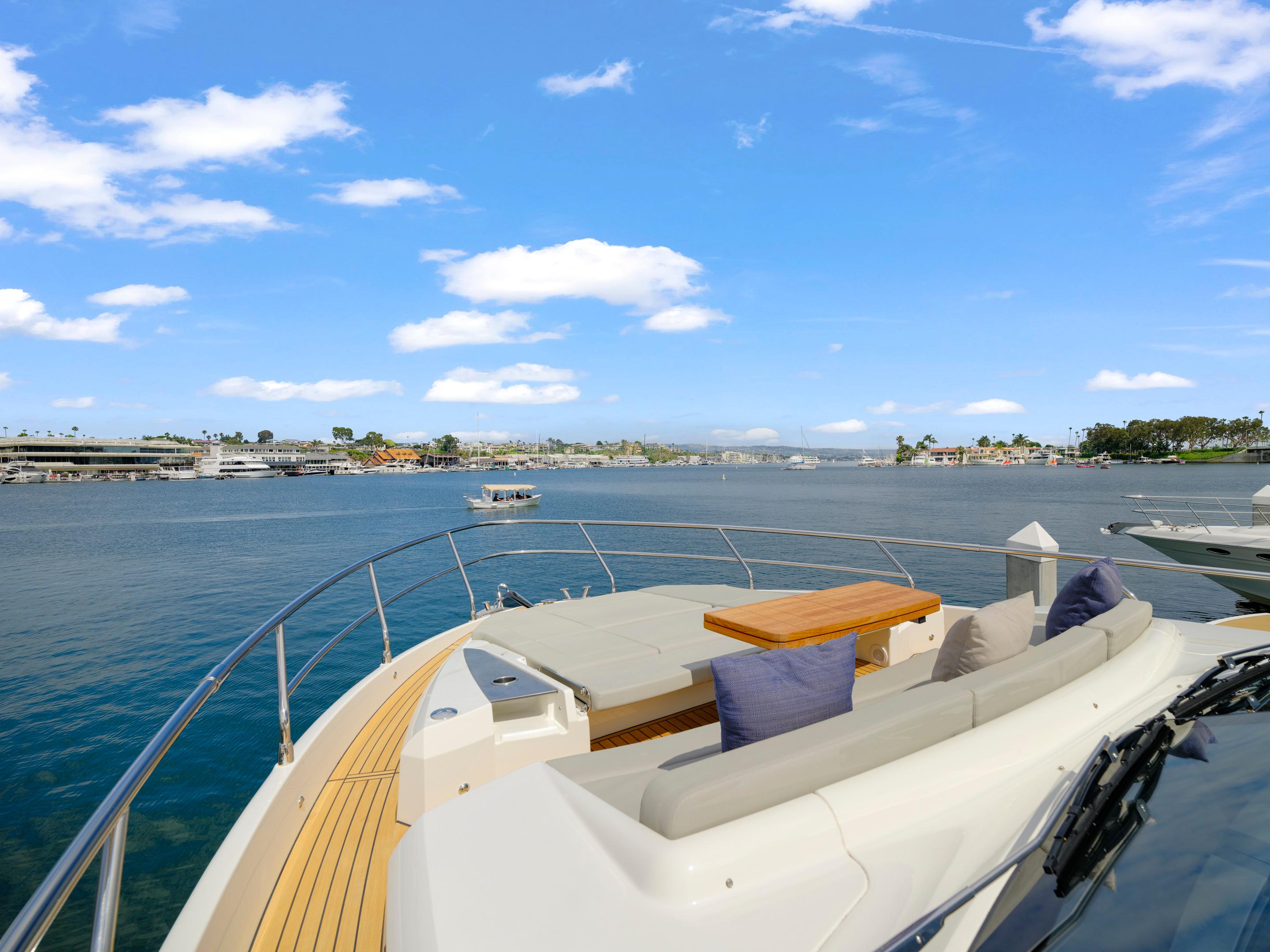 Luxurious 2024 Absolute 60 Fly yacht deck with scenic waterfront view.