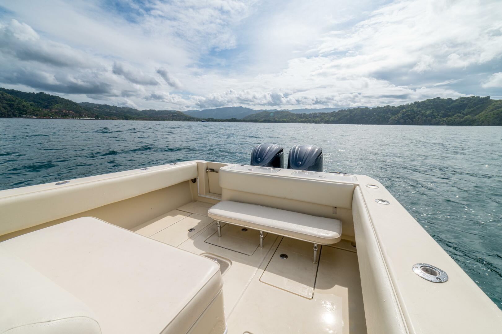 2007 Contender 33 boat on calm water, featuring spacious seating and twin engines.