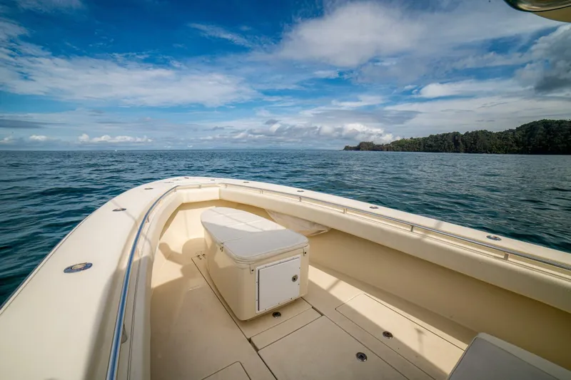 D Flawless Yacht Photos Pics 2007 Contender 33 boat on open sea with clear skies and distant shoreline.