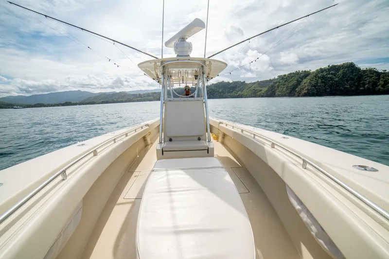 D Flawless Yacht Photos Pics 2007 Contender 33 boat on calm water with scenic mountain backdrop.